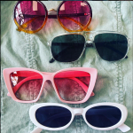 four pairs of sunglasses with frames of different colors and shapes