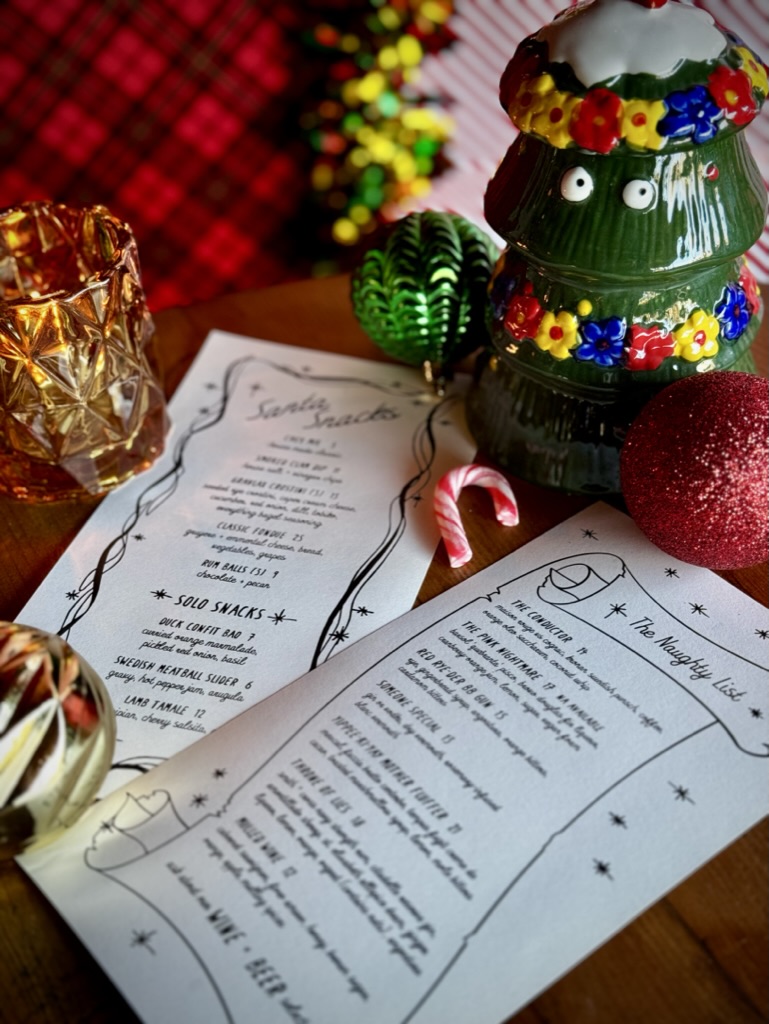 Menu on table with holiday decorations.