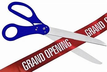 blue scissors cutting red Grand Opening ribbon